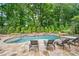 Beautifully landscaped pool area featuring a stone patio, spa and chaise lounges for ultimate comfort at 8109 Lawnview, Alpharetta, GA 30022