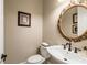 Elegant powder room featuring a decorative mirror and classic fixtures at 8109 Lawnview, Alpharetta, GA 30022