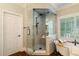 Bathroom showcasing walk-in shower with glass enclosure, rainfall showerhead, and a separate soaking tub at 8109 Lawnview, Alpharetta, GA 30022