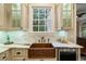 Kitchen sink with marble countertops and custom cabinetry at 8109 Lawnview, Alpharetta, GA 30022