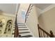 Staircase features dark wood stairs with white risers and a window on the landing at 8109 Lawnview, Alpharetta, GA 30022