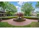 Picturesque street view showcasing a brick circle and lush landscaping leading to elegant homes and trees at 8109 Lawnview, Alpharetta, GA 30022