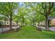 Tree-lined street view showcases a charming neighborhood with benches for residents to relax and enjoy the scenery at 8109 Lawnview, Alpharetta, GA 30022
