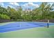 Blue and green colored outdoor tennis court at 8109 Lawnview, Alpharetta, GA 30022