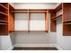 Spacious walk-in closet featuring custom wood shelving and rods for optimal storage and organization at 8109 Lawnview, Alpharetta, GA 30022