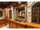 Elegant wet bar with wood counters, copper sinks, stone accents, and built-in wine storage at 8109 Lawnview, Alpharetta, GA 30022