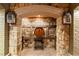 Beautiful stone wine cellar featuring brick flooring, ambient lighting, and decorative barrel accent at 8109 Lawnview, Alpharetta, GA 30022