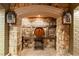 A charming wine cellar entrance with stone walls, brick flooring, and unique barrel decoration for a rustic feel at 8109 Lawnview, Alpharetta, GA 30022