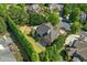 A residential property surrounded by mature trees, showing a manicured lawn, and a rear patio at 8745 Islesworth Ct, Duluth, GA 30097