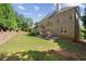 A spacious backyard featuring lush green lawn and a patio area with stylish outdoor furniture for relaxation at 8745 Islesworth Ct, Duluth, GA 30097
