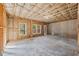Unfinished basement showing framed walls, windows and door to the exterior; ready to be personalized at 8745 Islesworth Ct, Duluth, GA 30097