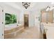 Bright bathroom with soaking tub, shower, and double vanity at 8745 Islesworth Ct, Duluth, GA 30097