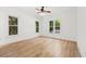 Bedroom with hardwood floors and multiple windows providing natural light at 8745 Islesworth Ct, Duluth, GA 30097