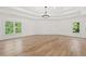Spacious primary bedroom featuring hardwood floors and natural light at 8745 Islesworth Ct, Duluth, GA 30097
