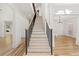 Elegant foyer with hardwood floors, staircase, and decorative columns at 8745 Islesworth Ct, Duluth, GA 30097