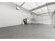 Spotless garage with stairs to the main house, and stainless steel fridge at 8745 Islesworth Ct, Duluth, GA 30097