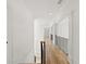 Upstairs hallway with hardwood flooring, and white trim at 8745 Islesworth Ct, Duluth, GA 30097