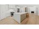 Bright kitchen with a large island, stainless appliances, and hardwood floors at 8745 Islesworth Ct, Duluth, GA 30097