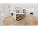 Bright kitchen with a large island, stainless appliances, and hardwood floors at 8745 Islesworth Ct, Duluth, GA 30097