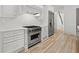 Stylish kitchen with stainless steel appliances, custom cabinets and hardwood floors at 8745 Islesworth Ct, Duluth, GA 30097