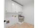 Bright laundry room with custom cabinets, stainless steel sink, and durable tile flooring at 8745 Islesworth Ct, Duluth, GA 30097