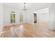 Open room with hardwood floors and white wainscoting, showcasing natural light from shuttered windows at 8745 Islesworth Ct, Duluth, GA 30097