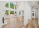 Sun-filled living room with hardwood floors, a fireplace, and tall windows with backyard views at 8745 Islesworth Ct, Duluth, GA 30097