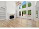 Charming living room with hardwood floors, built-in shelves, fireplace, and natural lighting at 8745 Islesworth Ct, Duluth, GA 30097