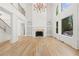 Bright and airy living room with hardwood floors, built-in bookcases, and a cozy fireplace at 8745 Islesworth Ct, Duluth, GA 30097