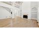Stunning living room featuring hardwood floors, fireplace, built-in shelves and lots of natural light at 8745 Islesworth Ct, Duluth, GA 30097