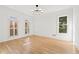 Bright room with hardwood floors, white walls, and window shutters adding a cozy touch at 8745 Islesworth Ct, Duluth, GA 30097