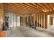 Unfinished basement with exposed wood framework and fitness equipment, offering potential for customization at 9115 Nesbit Lakes Dr, Alpharetta, GA 30022