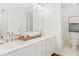 Bright bathroom featuring a double vanity with white cabinets and marble countertops and framed mirror at 9115 Nesbit Lakes Dr, Alpharetta, GA 30022