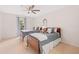 Bedroom with two beds, ceiling fan, neutral carpet, and matching bedside tables with lamps at 9115 Nesbit Lakes Dr, Alpharetta, GA 30022