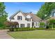 Charming home with manicured lawn and lush landscaping at 9115 Nesbit Lakes Dr, Alpharetta, GA 30022