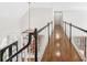 Hallway featuring hardwood floors and a decorative chandelier at 9115 Nesbit Lakes Dr, Alpharetta, GA 30022