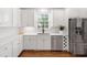 Contemporary kitchen featuring stainless steel appliances, white countertops, and hardwood floors at 9115 Nesbit Lakes Dr, Alpharetta, GA 30022
