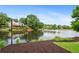 Beautiful lake view home with lush greenery creating a serene backdrop at 9115 Nesbit Lakes Dr, Alpharetta, GA 30022