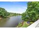 Scenic lake view showcasing lush greenery, a charming seating area, and the tranquil waters of the lake at 9115 Nesbit Lakes Dr, Alpharetta, GA 30022