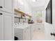 Clean and organized laundry room with white cabinets, modern appliances, and ample storage space at 9115 Nesbit Lakes Dr, Alpharetta, GA 30022