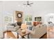 Bright living room with a stone fireplace, seating area, and hardwood floors, creating a warm and inviting atmosphere at 9115 Nesbit Lakes Dr, Alpharetta, GA 30022