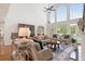 Spacious living room featuring hardwood floors, plenty of seating, and bright windows with a backyard view at 9115 Nesbit Lakes Dr, Alpharetta, GA 30022