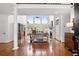 Bright living room with soaring windows, hardwood floors, and stylish decor, perfect for relaxation at 9115 Nesbit Lakes Dr, Alpharetta, GA 30022