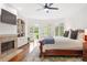 Spacious main bedroom with a fireplace, built-in bookshelves, and access to a private balcony at 9115 Nesbit Lakes Dr, Alpharetta, GA 30022