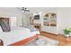 Comfortable main bedroom with a fireplace, built-in shelving, and a cozy rug at 9115 Nesbit Lakes Dr, Alpharetta, GA 30022