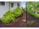 Stairway leading to backyard with mature landscaping and a retaining wall at 9115 Nesbit Lakes Dr, Alpharetta, GA 30022