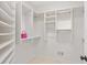Spacious walk-in closet with custom shelving and hanging rods at 9115 Nesbit Lakes Dr, Alpharetta, GA 30022