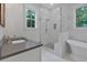 Modern bathroom featuring a glass shower, soaking tub, and ample counter space, all with a view at 12 Cedar Gate Ln, Kingston, GA 30145