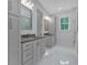 Spacious bathroom with double vanity, marble floors, storage cabinets, and a large framed mirror at 12 Cedar Gate Ln, Kingston, GA 30145