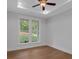 Bedroom with wood floors, large windows, a modern ceiling fan, and a neutral color palette at 12 Cedar Gate Ln, Kingston, GA 30145